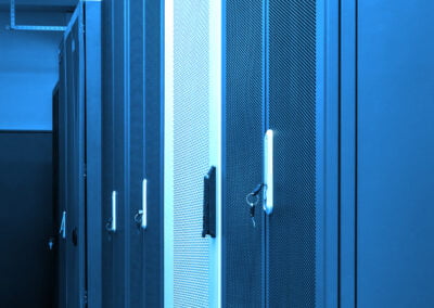 Row of closed racks clusters with servers and routers in big data centre with neon blue toning. Powerful internet, telecommunication equipment. Server room inside